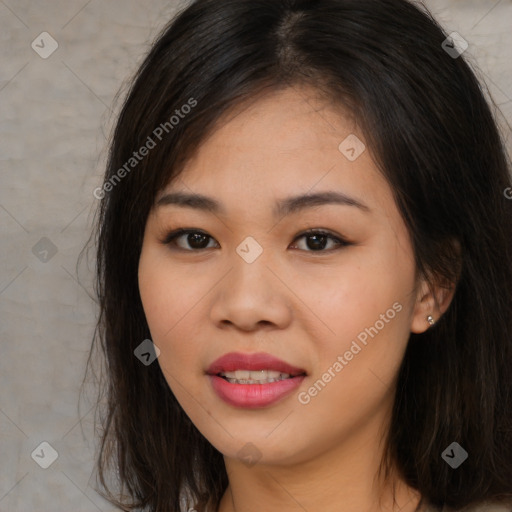 Joyful asian young-adult female with long  brown hair and brown eyes