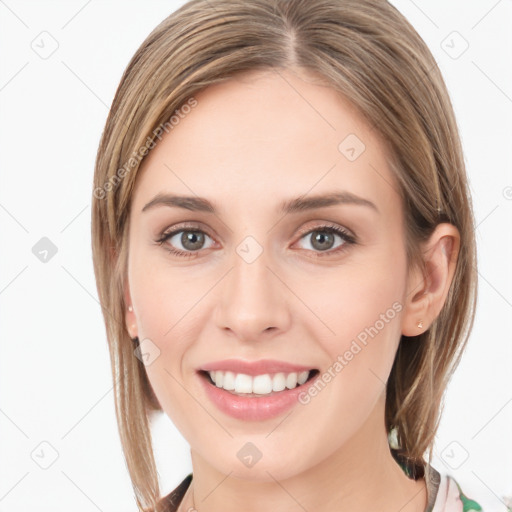 Joyful white young-adult female with long  brown hair and grey eyes