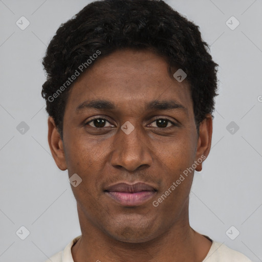 Joyful black young-adult male with short  black hair and brown eyes