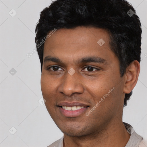 Joyful black young-adult male with short  black hair and brown eyes