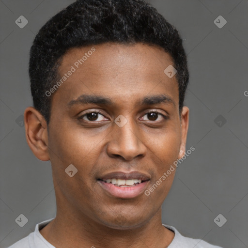 Joyful black young-adult male with short  brown hair and brown eyes