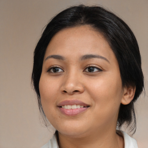 Joyful asian young-adult female with medium  black hair and brown eyes