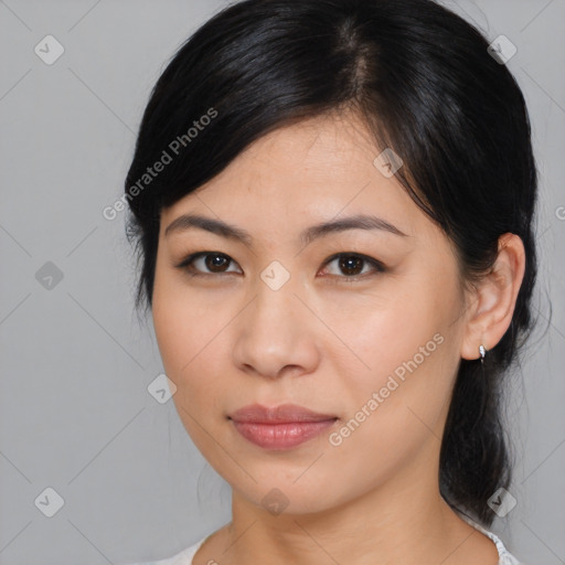 Joyful asian young-adult female with medium  black hair and brown eyes