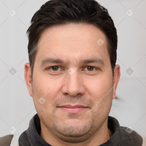 Joyful white adult male with short  brown hair and brown eyes