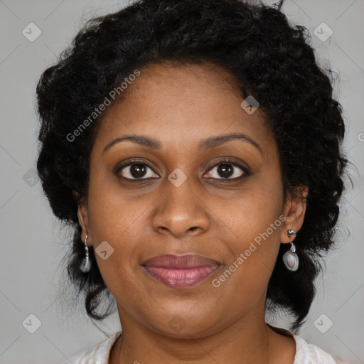 Joyful black adult female with long  brown hair and brown eyes