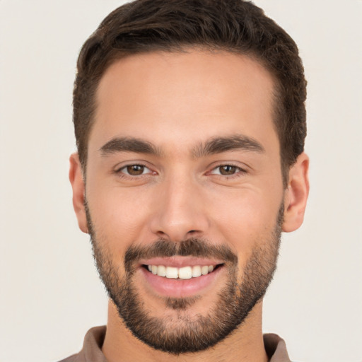 Joyful white young-adult male with short  brown hair and brown eyes