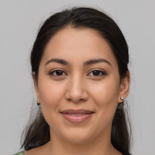 Joyful latino young-adult female with medium  brown hair and brown eyes