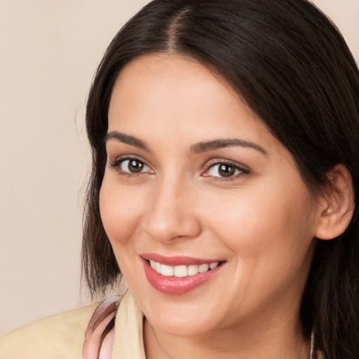 Joyful white young-adult female with long  brown hair and brown eyes