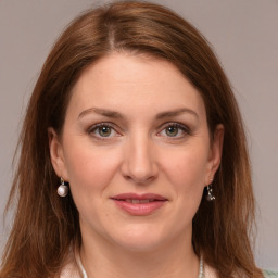 Joyful white young-adult female with medium  brown hair and grey eyes