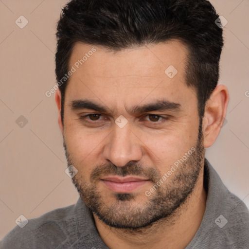 Joyful white young-adult male with short  black hair and brown eyes