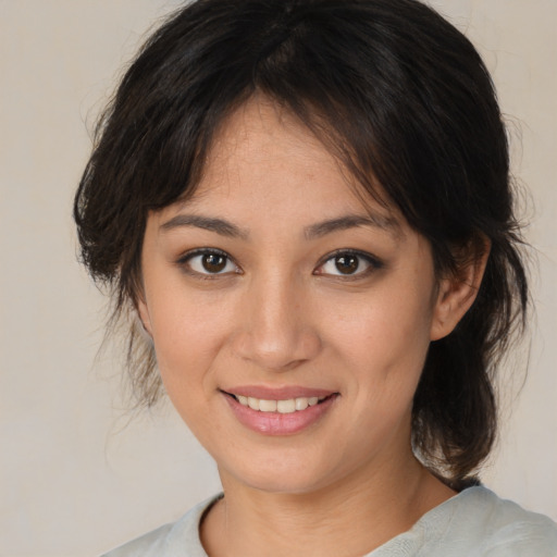 Joyful white young-adult female with medium  brown hair and brown eyes