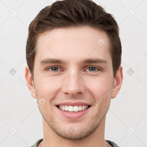 Joyful white young-adult male with short  brown hair and grey eyes