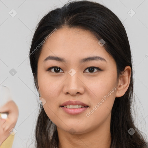 Joyful asian young-adult female with long  brown hair and brown eyes