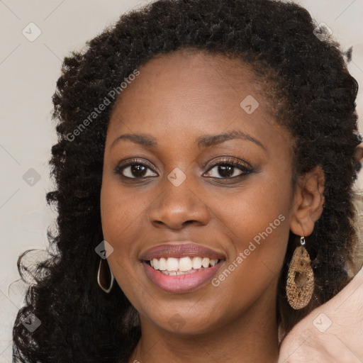 Joyful black young-adult female with long  brown hair and brown eyes