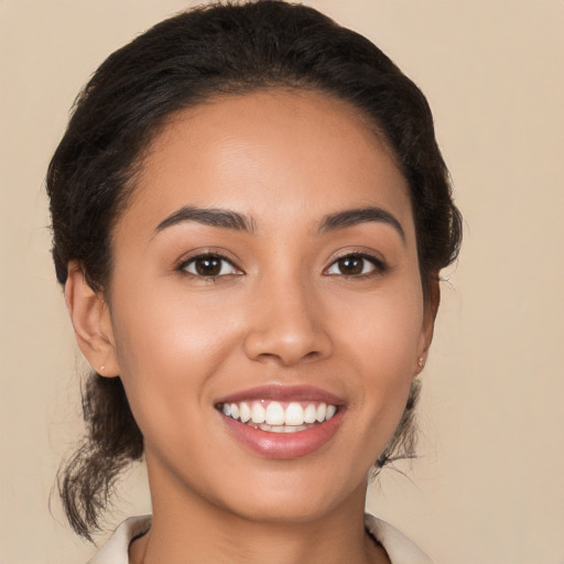 Joyful latino young-adult female with medium  brown hair and brown eyes