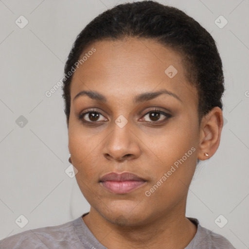 Joyful black young-adult female with short  black hair and brown eyes