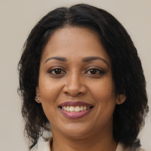 Joyful black young-adult female with medium  brown hair and brown eyes