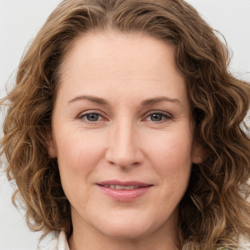 Joyful white young-adult female with medium  brown hair and green eyes