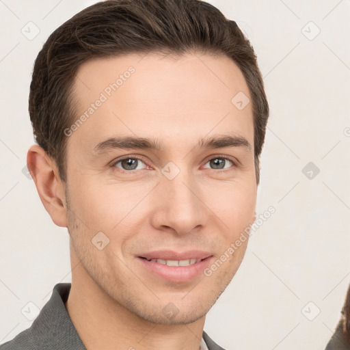 Joyful white young-adult male with short  brown hair and grey eyes