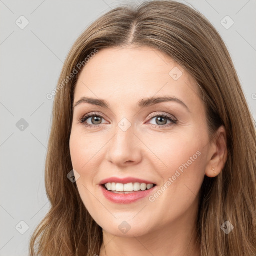 Joyful white young-adult female with long  brown hair and grey eyes