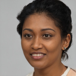 Joyful black young-adult female with medium  brown hair and brown eyes