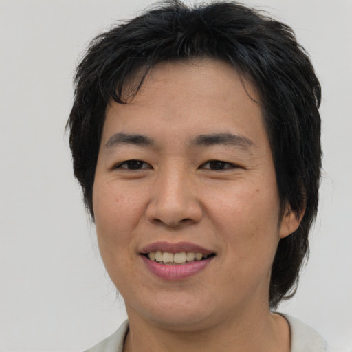 Joyful asian young-adult male with medium  brown hair and brown eyes