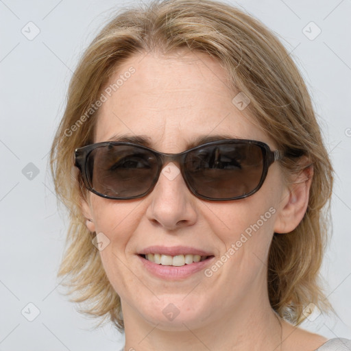 Joyful white adult female with medium  brown hair and blue eyes