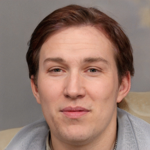 Joyful white adult male with short  brown hair and blue eyes