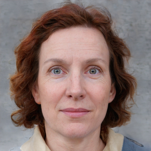 Joyful white adult female with medium  brown hair and blue eyes