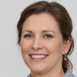 Joyful white adult female with medium  brown hair and grey eyes