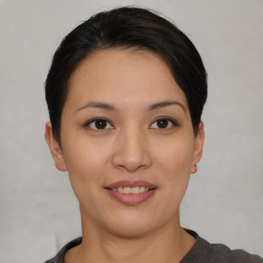 Joyful asian young-adult female with short  black hair and brown eyes