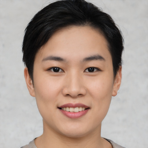 Joyful asian young-adult female with short  black hair and brown eyes