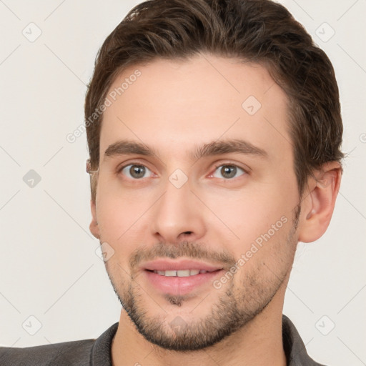 Joyful white young-adult male with short  brown hair and brown eyes