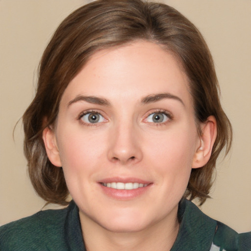 Joyful white young-adult female with medium  brown hair and green eyes