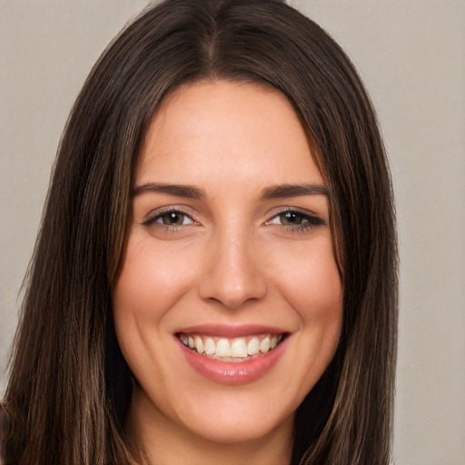 Joyful white young-adult female with long  brown hair and brown eyes