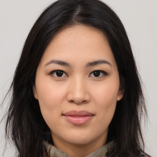 Joyful asian young-adult female with long  brown hair and brown eyes