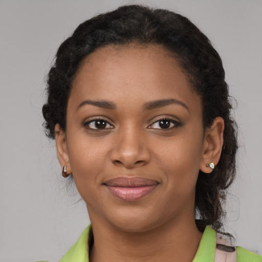 Joyful black young-adult female with medium  black hair and brown eyes