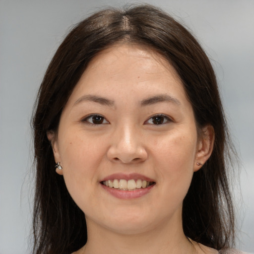 Joyful asian young-adult female with medium  brown hair and brown eyes