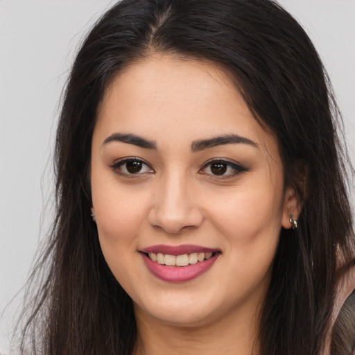 Joyful white young-adult female with long  brown hair and brown eyes