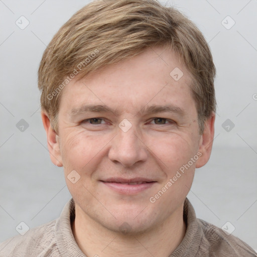 Joyful white adult male with short  brown hair and grey eyes