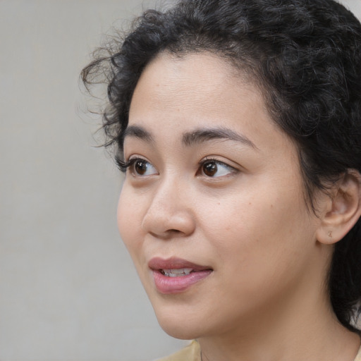 Joyful white young-adult female with medium  black hair and brown eyes