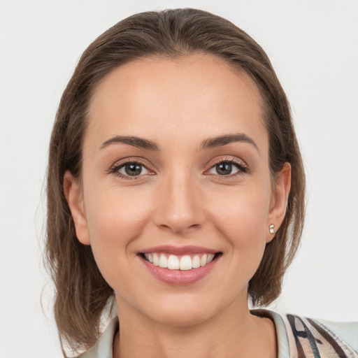 Joyful white young-adult female with medium  brown hair and grey eyes