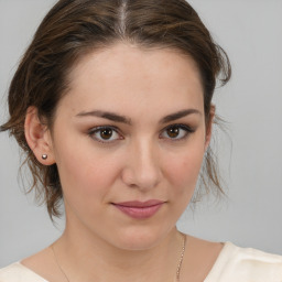 Joyful white young-adult female with medium  brown hair and brown eyes