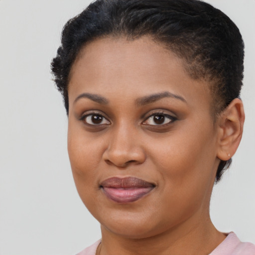 Joyful black young-adult female with short  brown hair and brown eyes