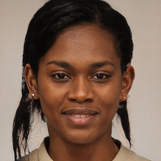 Joyful black young-adult female with medium  black hair and brown eyes