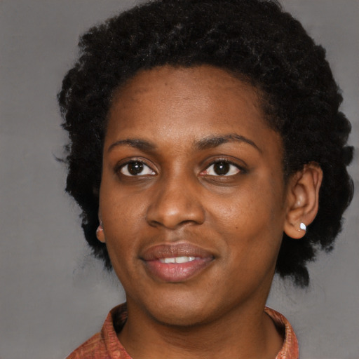 Joyful black young-adult female with short  black hair and brown eyes