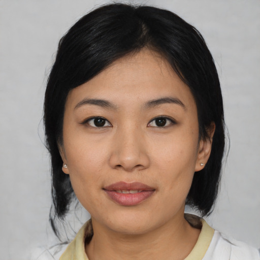 Joyful asian young-adult female with medium  black hair and brown eyes