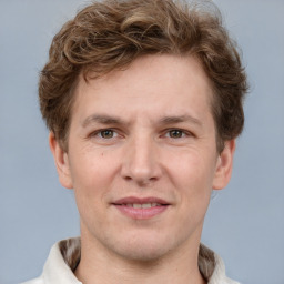 Joyful white adult male with short  brown hair and grey eyes