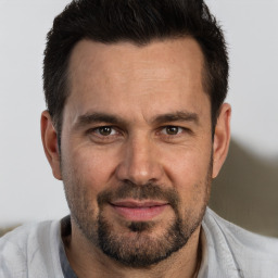 Joyful white adult male with short  brown hair and brown eyes