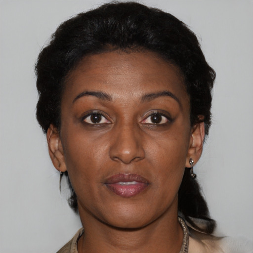 Joyful black adult female with short  brown hair and brown eyes